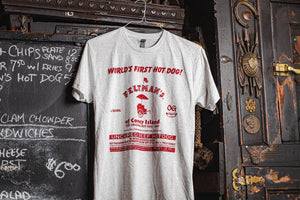 Feltman's t-shirt, white in color with red text hanging in a pub.